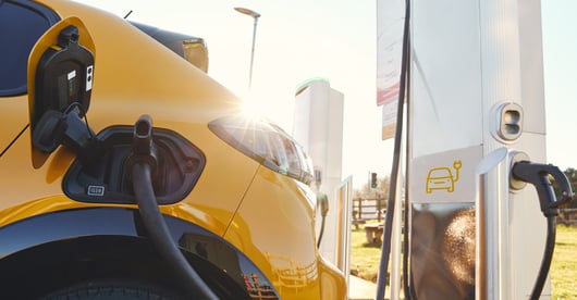 A close up of an electric car while charging